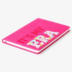 A5 pink notebook with pom poms