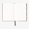 Burgundy notebook with text