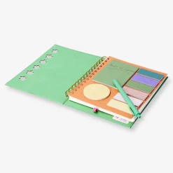 Green notebook with ballpoint pen and memos
